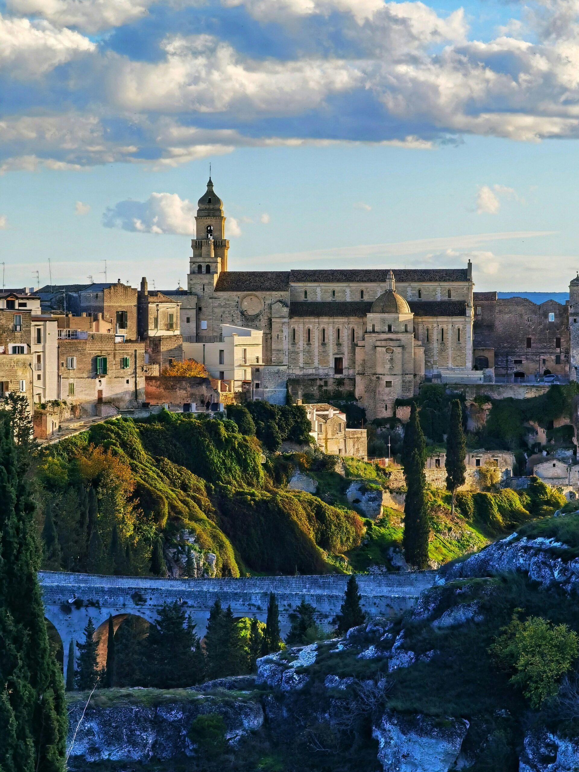 Kamienny most Madonna della Stella i panorama miasteczka Gravina in Puglia na południu Włoch.